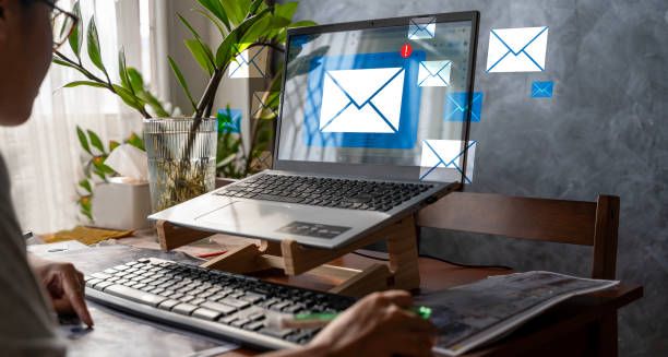 Person framför laptop med överlappande ikoner för e-post och meddelanden.